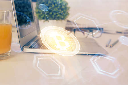 Double exposure of blockchain theme hologram and table with computer background. Concept of bitcoin...