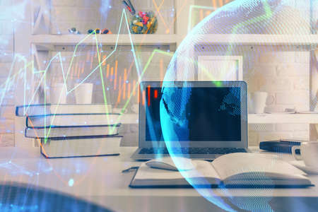 Financial chart drawing and table with computer on background. Multi exposure. Concept of...