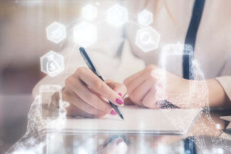 Technology theme hologram over womans hands taking notes background. Concept of Tech. Double...