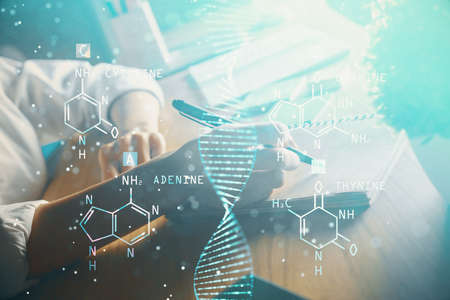 DNA theme hologram over womans hands writing background. Concept of education. Double exposureの写真素材