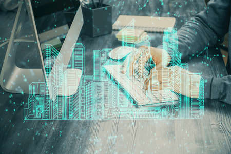 High tech city drawing with businessman working on computer on background. Smartcity concept. Double...