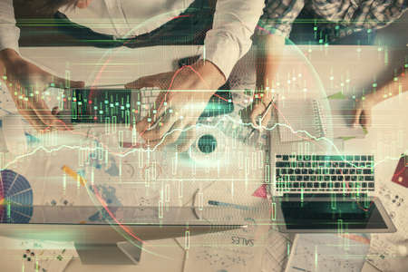Double exposure of man and woman working together and financial chart hologram drawing. market...