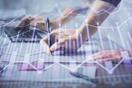 Multi exposure of woman hands typing on computer and financial chart hologram drawing. Stock market analysis concept.の写真素材