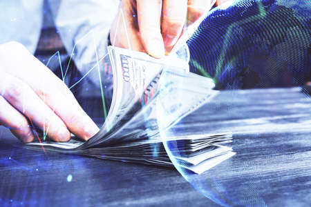 Multi exposure of forex graph drawing hologram and USA dollars bills and man hands. Technical...