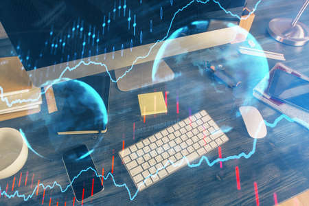 Multi exposure of chart and financial info and work space with computer background. Concept of...