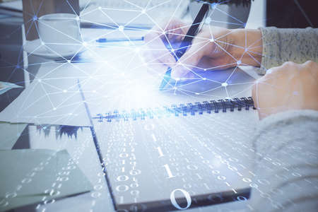 Double exposure of writing hand on background with data solution technology hologram. Ai concept.
