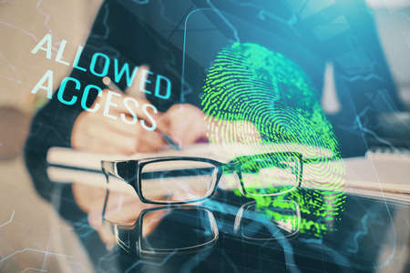 Blue fingerprint hologram over womans hands taking notes background. Concept of protection. Double...