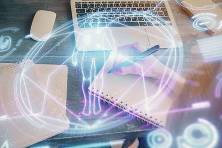 Education theme hologram over womans hands writing background. Concept of study. Double exposure
