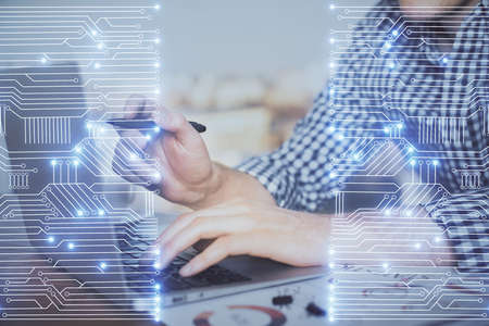 Technology theme hologram with man working on computer on background. High tech concept. Double...