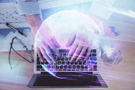 Technology theme hologram with man working on computer on background. High tech concept. Double exposure.の写真素材
