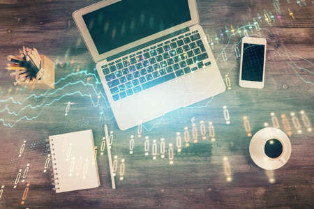 Double exposure of forex chart drawing over table background with computer. Concept of financial...