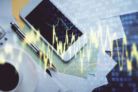 Multi exposure of forex graph hologram over desktop with phone. Top view. Mobile trade platform...