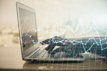 Double exposure of woman hands typing on computer and forex chart hologram drawing. Stock market invest concept.の写真素材