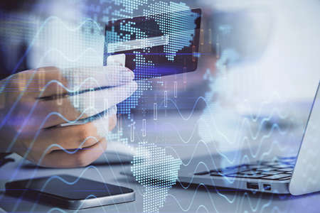 Multi exposure of woman on-line shopping holding a credit card and financial graph drawing. Stock...