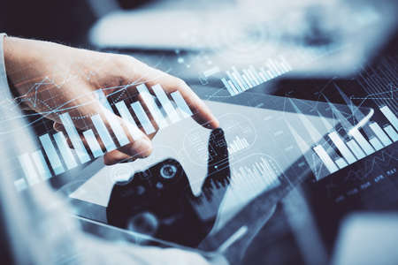 Multi exposure of mans hands holding and using a phone and financial chart drawing. Market analysis...