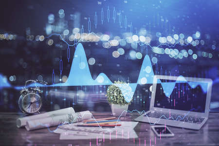 Forex market graph hologram and personal computer on background. Multi exposure. Concept of...