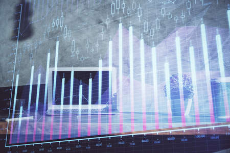 Multi exposure of graph and financial info and work space with computer background. Concept of...