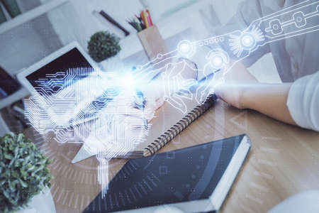 Multi exposure of writing hand on background with brain hologram. Concept of learning.