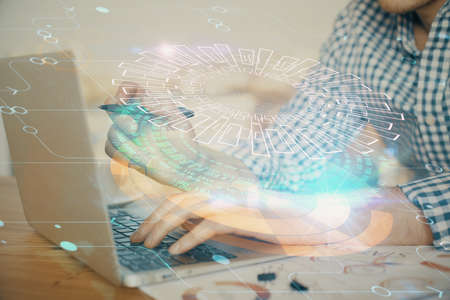 Businessman with computer background with technology theme hologram. Concept of hightech. Multi...