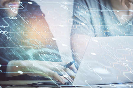 Multi exposure of data internet theme hologram with man working on computer on background. Concept...