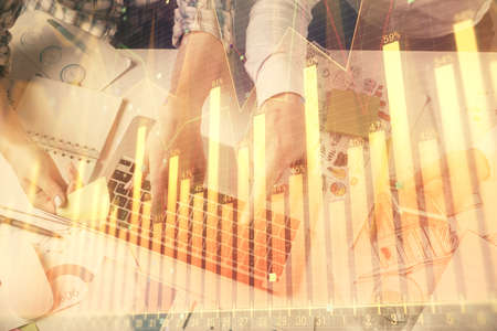 Multi exposure of man and woman working together and forex graph hologram drawing. Financial...