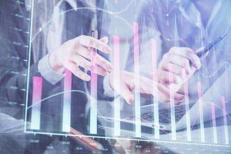 Multi exposure of man and woman working together and financial chart hologram. Business concept....