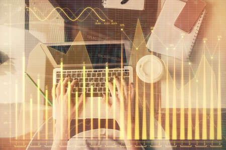 Double exposure of woman hands working on computer and forex chart hologram drawing. Top View. Financial analysis concept.の写真素材