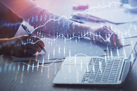 Double exposure of businesswoman hands typing on computer and forex chart hologram drawing....