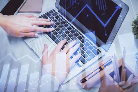 Multi exposure of woman hands typing on computer and forex chart hologram drawing. Stock market analysis concept.の写真素材