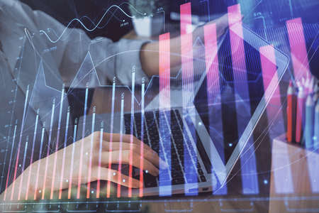 Double exposure of woman hands typing on computer and forex chart hologram drawing. Stock market...