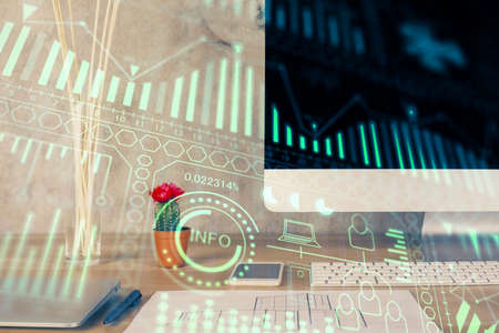 Computer on desktop in office with technology theme hologram. Double exposure. Tech concept.の写真素材