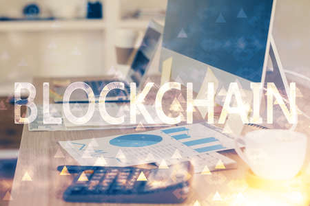 Double exposure of blockchain theme hologram and table with computer background. Concept of bitcoin...