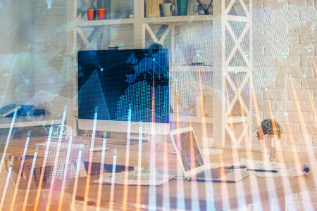 Financial graph colorful drawing and table with computer on background. Double exposure. Concept of international markets.の写真素材
