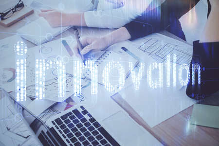 Double exposure of womans writing hand on background with data technology hud. Big data concept.の写真素材