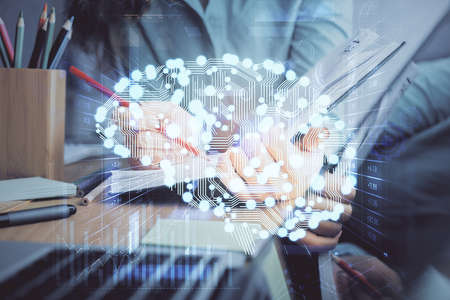 Double exposure of womans writing hand on background with brain hud. Concept of learning.