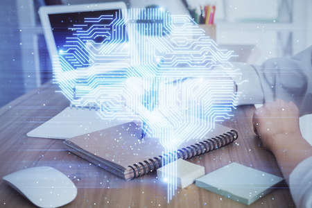 Multi exposure of writing hand on background with brain hologram. Concept of self learning.