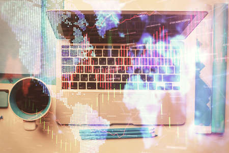 Double exposure of forex graph drawing over desktop background with computer. Concept of financial...