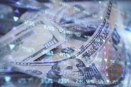 Double exposure of forex graph drawing over us dollars bill background. Concept of financial...