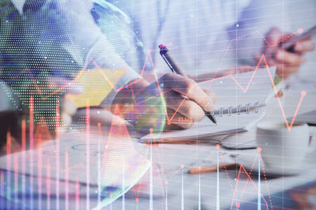 Double exposure of forex graph drawing over people taking notes background. Concept of financial...