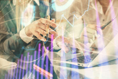 Double exposure of man and woman working together and forex chart hologram. Business concept....