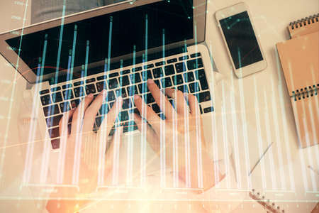 Double exposure of woman hands working on computer and forex chart hologram drawing. Top View....