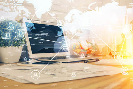 Computer on desktop with social network hologram. Multi exposure. Concept of international people...