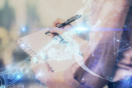 Technology theme hologram over womans hands taking notes background. Concept of Tech. Double...