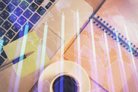 Stock market graph and top view computer on the table background. Double exposure. Concept of...