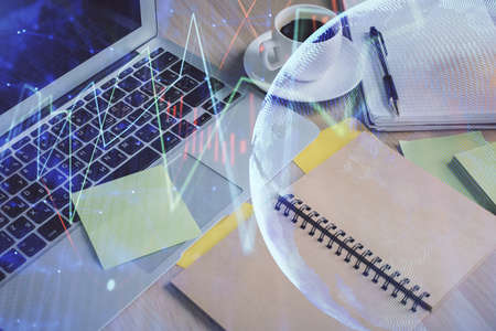 Multi exposure of forex graph drawing and desktop with coffee and items on table background. Concept...