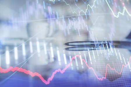 Double exposure of forex chart over coffee cup background in office. Concept of financial analysis...