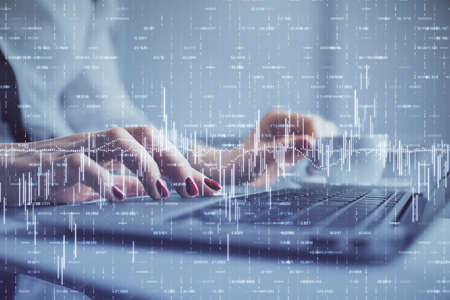 Multi exposure of woman hands typing on computer and financial graph hologram drawing. Stock market...