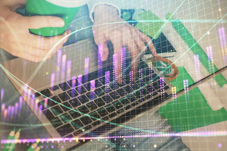 Double exposure of woman hands typing on computer and forex chart hologram drawing. Stock market...