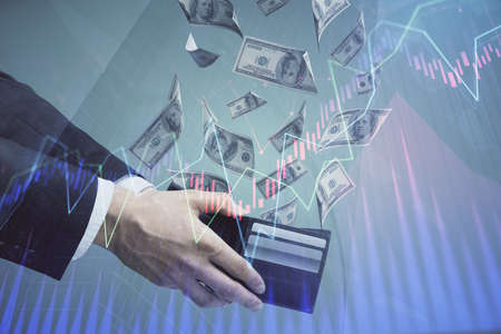 Multi exposure of financial graph drawing hologram and USA dollars bills and man hands. Analysis...