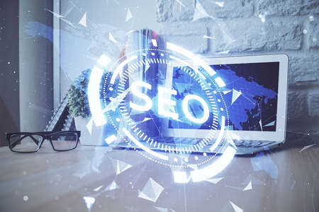 Multi exposure of table with computer and seo drawing hologram. Search optimization concept.の写真素材